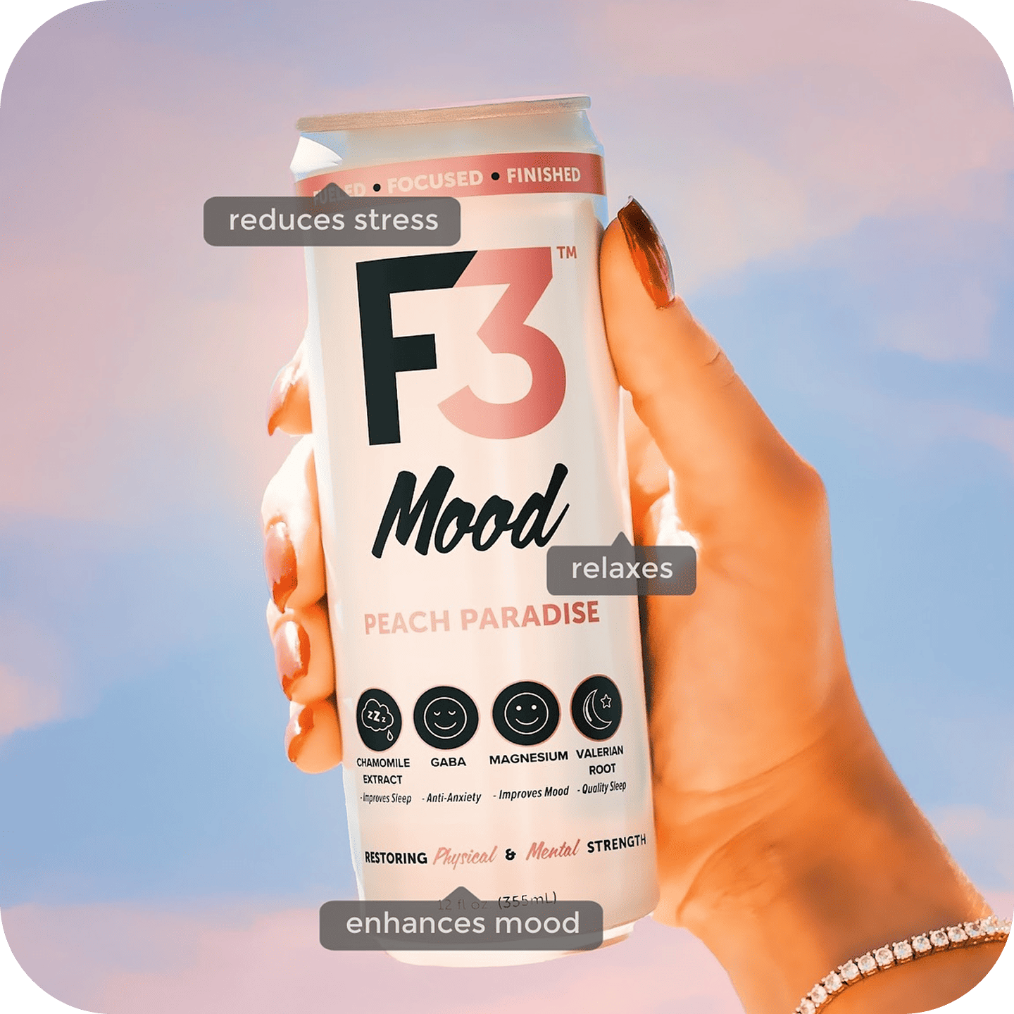 A single palm leaf in a clear glass of water on a white background.